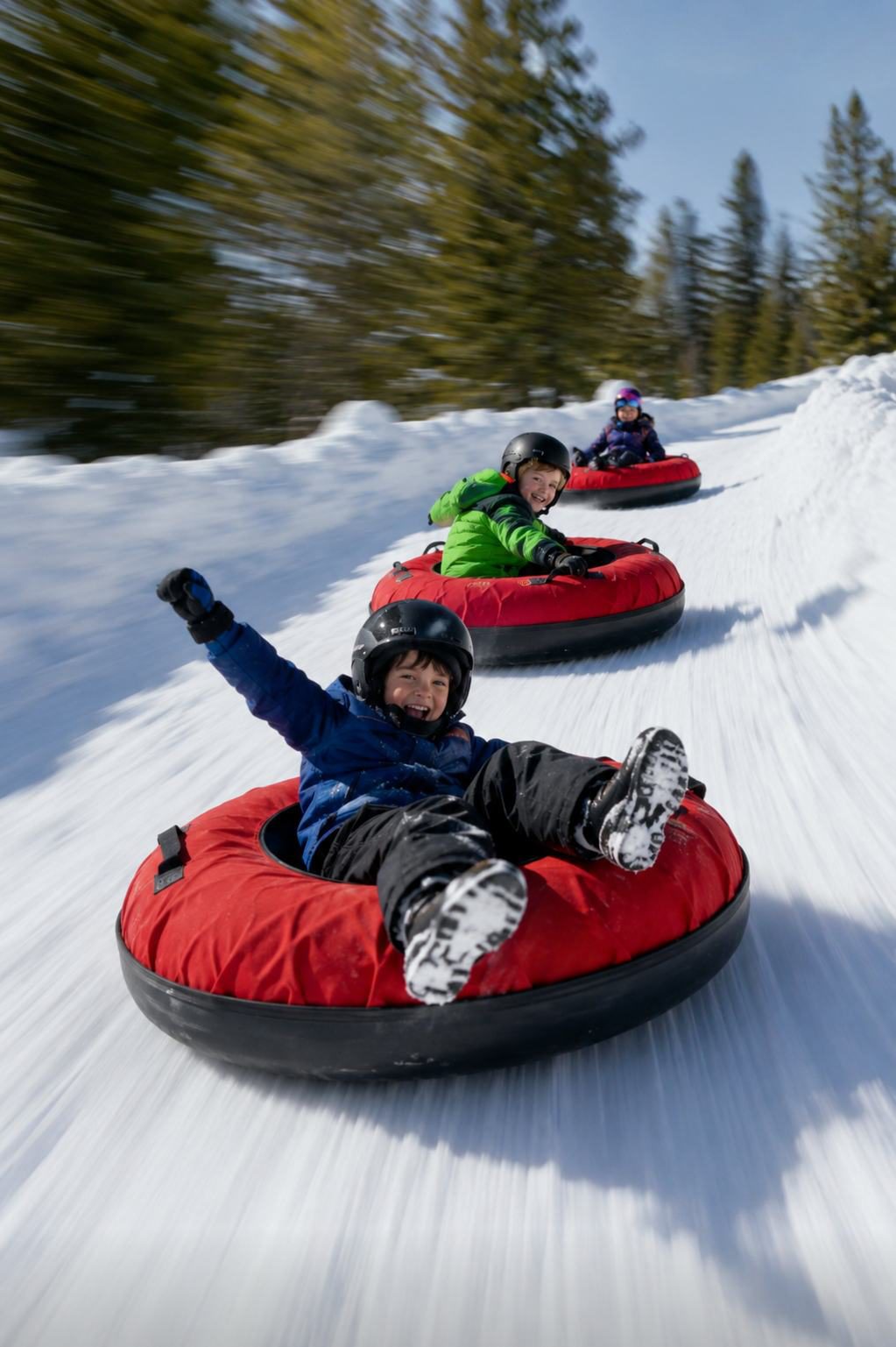 Kids sliding down the tubing lanes