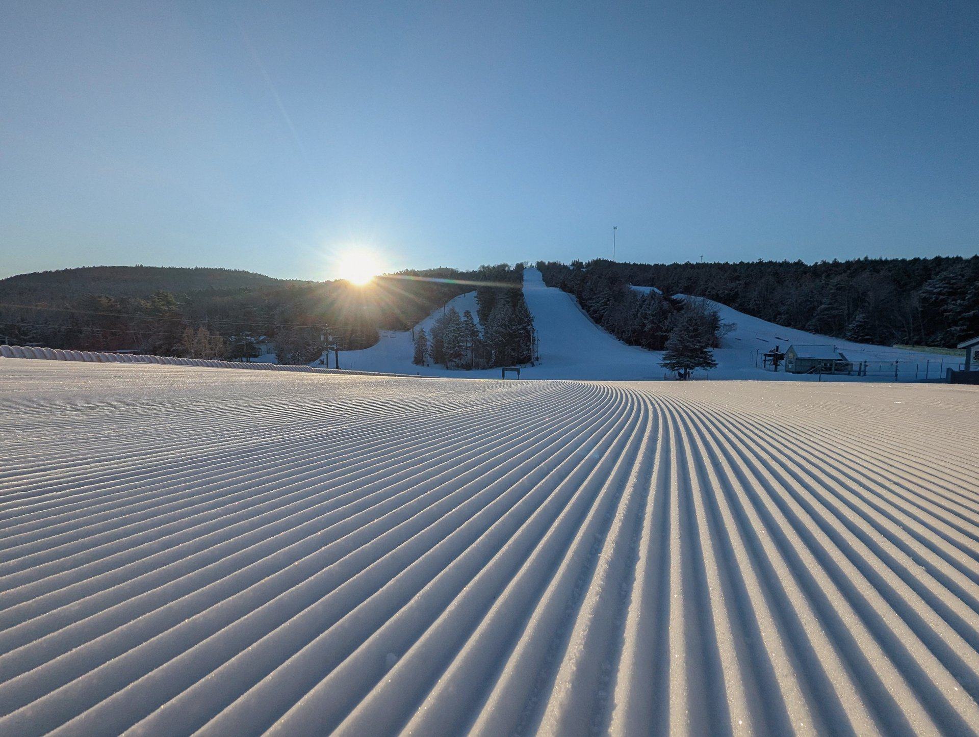 Fresh corduroy grooming at sunrise on the Martock slopes